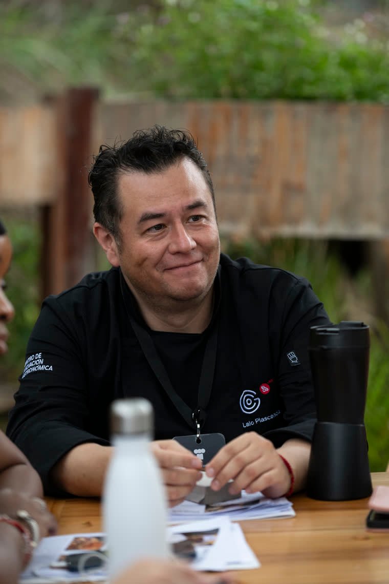 A chef from the group listens with a smile during the meeting.