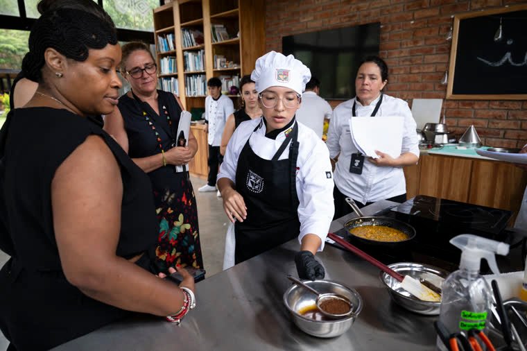 Judges closely watch the preparation at a station.