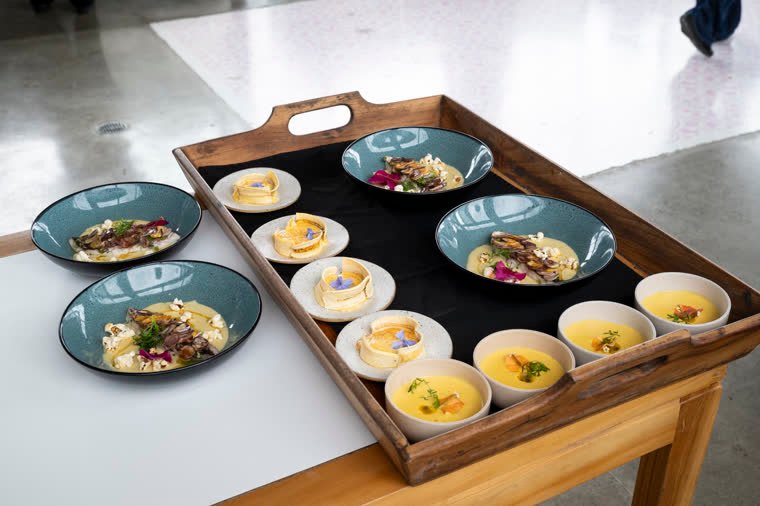 Tray with the dishes of one presentation: bowls, ceramic plates and individual portions.