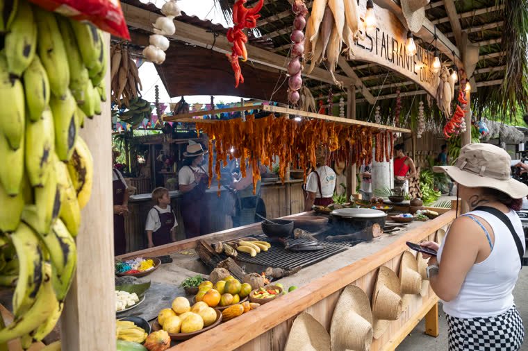 The restaurant’s open kitchen with plantains, chili peppers and hanging meats.